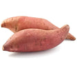 Two whole unpeeled sweet potatoes with smooth reddish brown skin and tapered ends perfect for sweet potato recipes