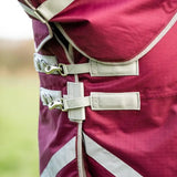 Maroon burgundy turnout rug with beige straps and silver buckles featuring detachable neck turnout design