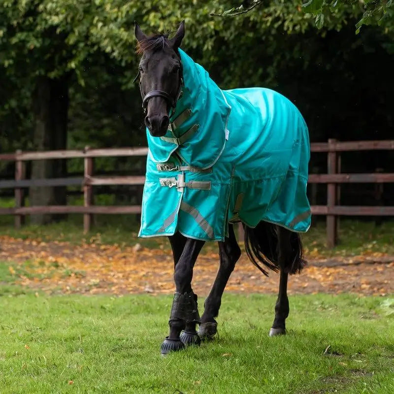 A vibrant turquoise turnout rug peppermint with reflective silver stripes and detachable neck liner attachments for horses