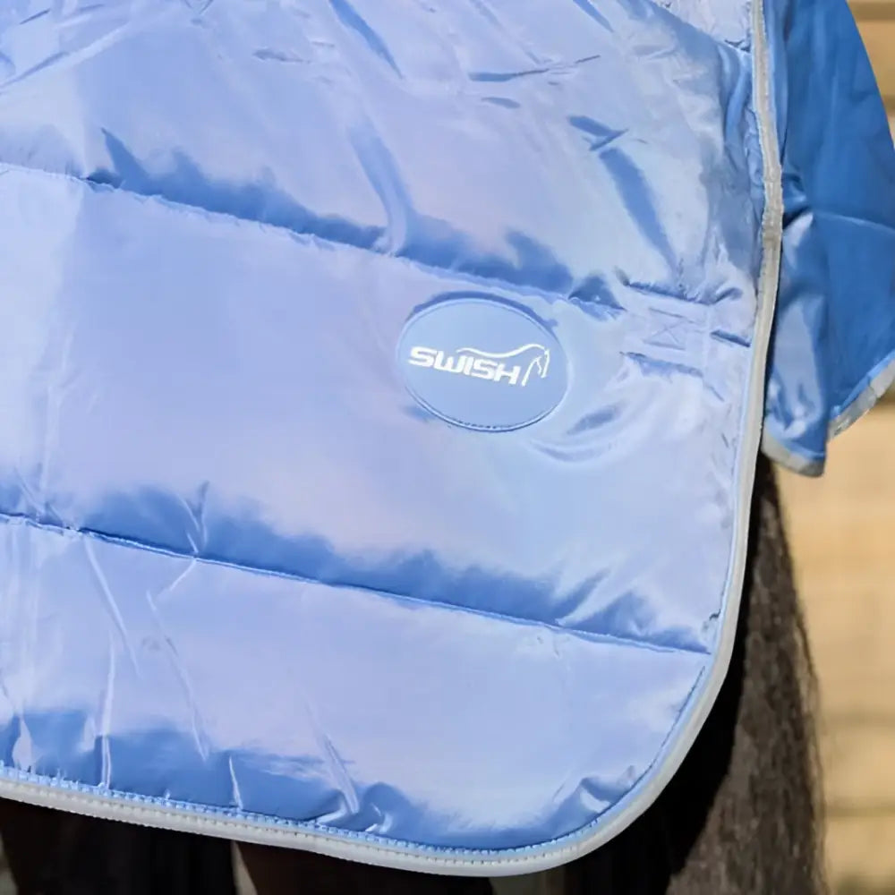 Lightweight stable rug in cornflower with quilted design detachable neck and soft nylon lining with silver swish patch
