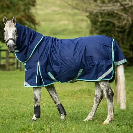 Navy blue medium weight turnout rug with detachable neck turnout and liner attachments featuring teal trim and reflective stripes
