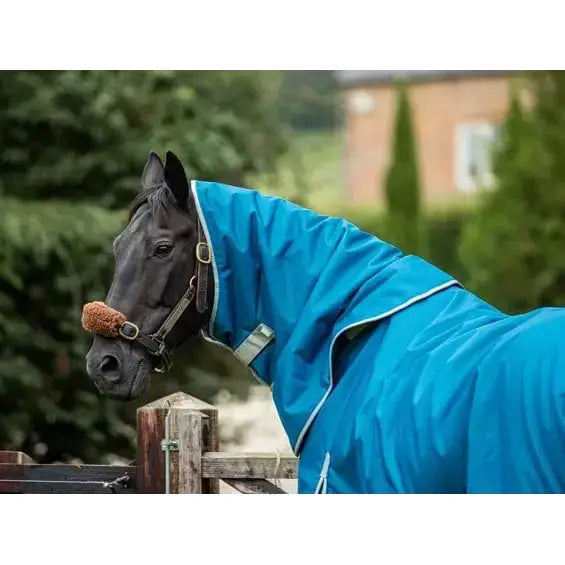 A black horse wearing a turquoise swish 200g turnout rug neck cover made of durable 1200d ripstop fabric
