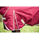 A maroon swish 450g ultimate heavyweight turnout rug with white trim, reflective strips safety, and adjustable straps