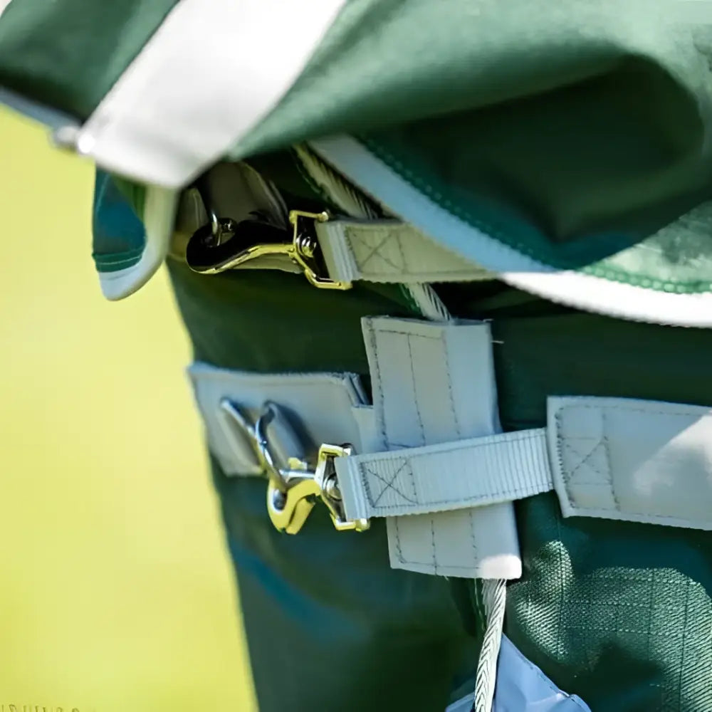Swish 50g detachable neck turnout rug in hunter green with white trim and light gray adjustable straps featuring metallic buckles