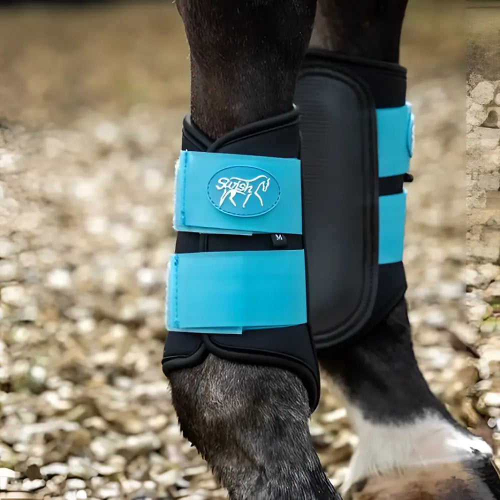 Bright turquoise and black swish double locking brushing boots with padded strike pad and breathable neoprene material
