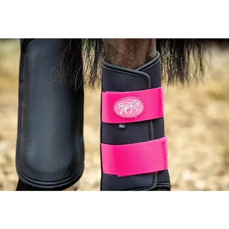 Black and vibrant pink swish double locking brushing boots with breathable neoprene and padded strike pad design