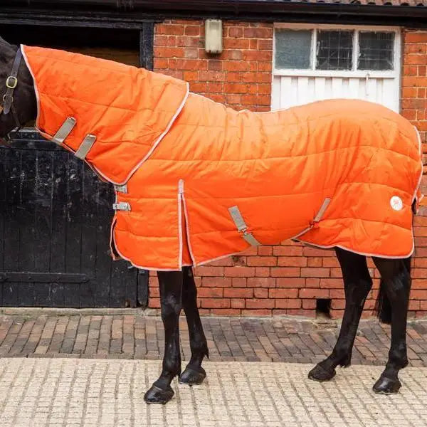Bright orange small display stable rug with quilted material gray reflective straps and white logo neck cover