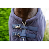 Navy blue quilted fleece horse rug with breathable cross surcingles and silver piping featuring adjustable straps and buckles