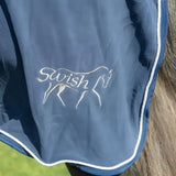 Navy plush swish fleece rug with fixed neck cover white embroidered logo and cross surcingles trim for horses