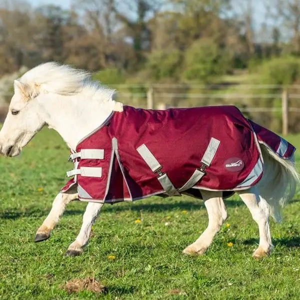 Maroon mini 0g turnout rug burgundy with silver reflective strips black logo and cross surcingles for small horses