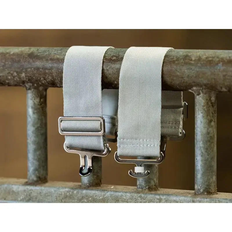 Two light gray elastic surcingle extenders with silver buckles and hooks for adjustable equestrian use on horses