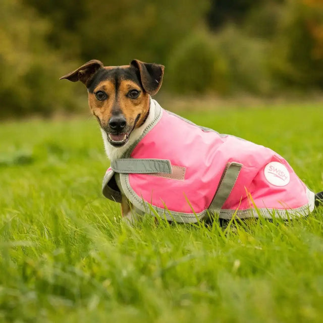 Bright pink swish waterproof dog coat with reflective strips and velcro chest shown from the back side