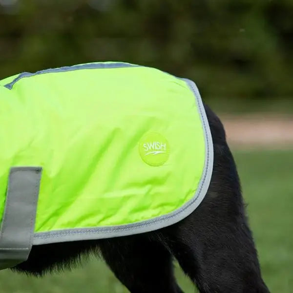 Bright neon green waterproof dog coat with reflective strips gray trim velcro chest and circular swish logo patch