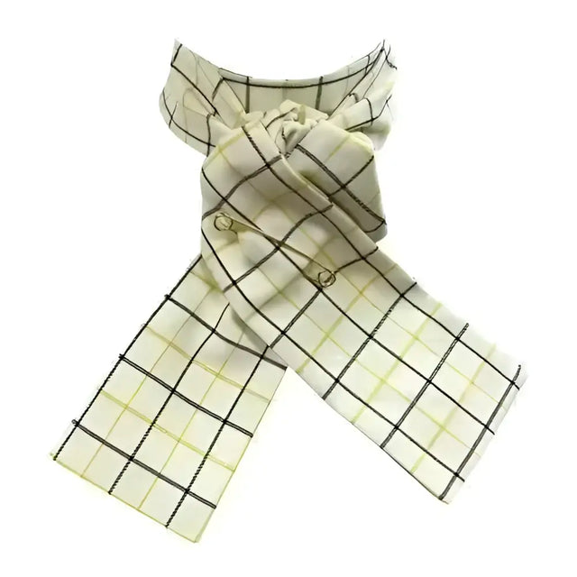 A cream-colored tattersall check riding stock with black and pale yellow grid pattern and gold-toned safety pins