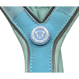 A light blue btactical harness with slip-on design and a circular patch promoting leash manners and smarter use