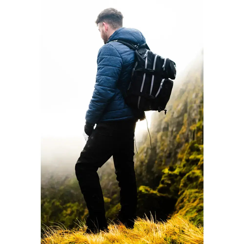 Black 35l btactical backpack with reflective silver stripes and multiple compartments for versatile use