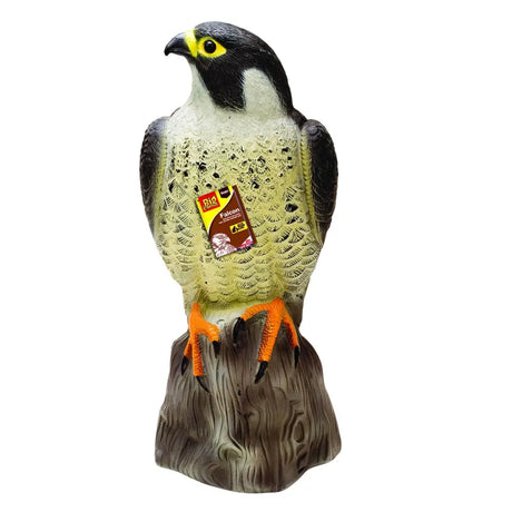 A big cheese falcon lifelike plastic decoy with black and white plumage yellow eyes and orange feet on a wooden base
