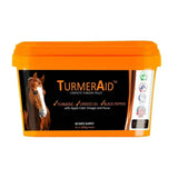Bright orange plastic tub of turmeraid pelleted turmeric supplement by the golden paste company for horses