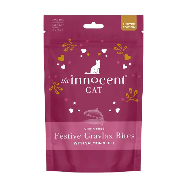 A vibrant magenta pouch of innocent cat festive grain free cat festive bites with white cat silhouette and gold leaf accents