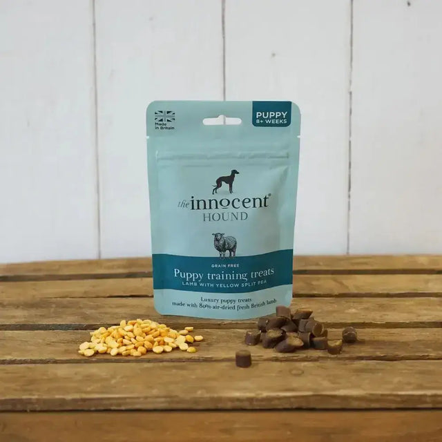 A light blue pouch of innocent hound puppy training succulent puppy treats grain free with lamb and yellow split pea