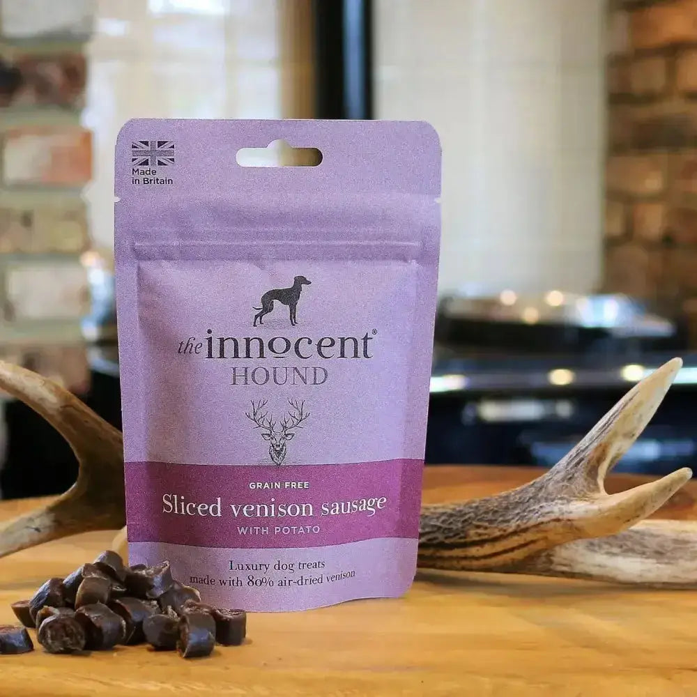 Purple pouch of innocent hound sliced venison sausage dog treats with potato grain free featuring black logo