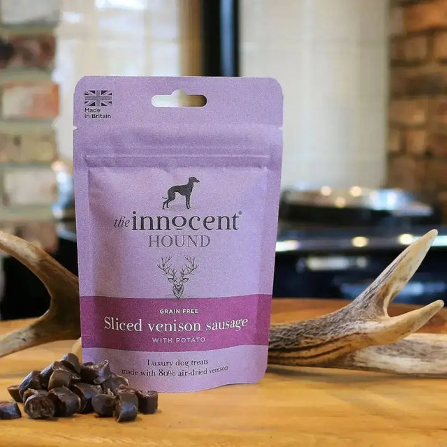 Purple pouch of innocent hound sliced venison sausage dog treats with potato grain free featuring black logo