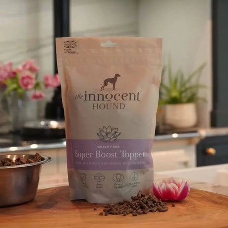 A beige and purple bag of innocent hound super boost topper dog food with natural active ingredients and lotus design