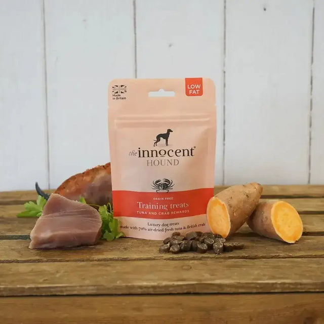 A pink and orange innocent hound pouch of grain-free training treats with succulent sliced tuna and crab rewards