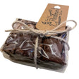 A clear wrapped rich dark chocolate brownie slice from the old parlour bakes with a rustic brown paper tag north devon
