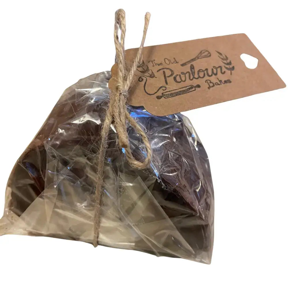 A brown paper tag with twine from the old parlour bakes featuring whisk and rolling pin for north devon parlour bakes brownie roll slice