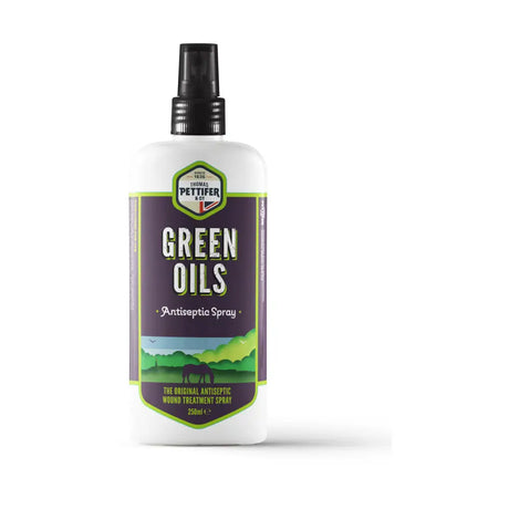 White plastic spray bottle labeled thomas pettifer green oils antiseptic spray with green and purple hills and horse design