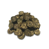 A pile of tightly rolled dark green and golden brown thunderbrook hay flakes horse feed forage replacement balls