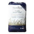A 15kg bag of thunderbrook healthy herbal chaff horse feed with navy blue white packaging and late cut meadow grass illustration