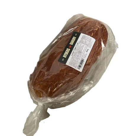 A brown crusty tiger bread loaf wrapped in clear plastic with a ryders bakery label on the front