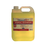 A 5 liter jug of triamvet animal shampoo with translucent yellow concentrated shampoo and a white plastic handle and cap