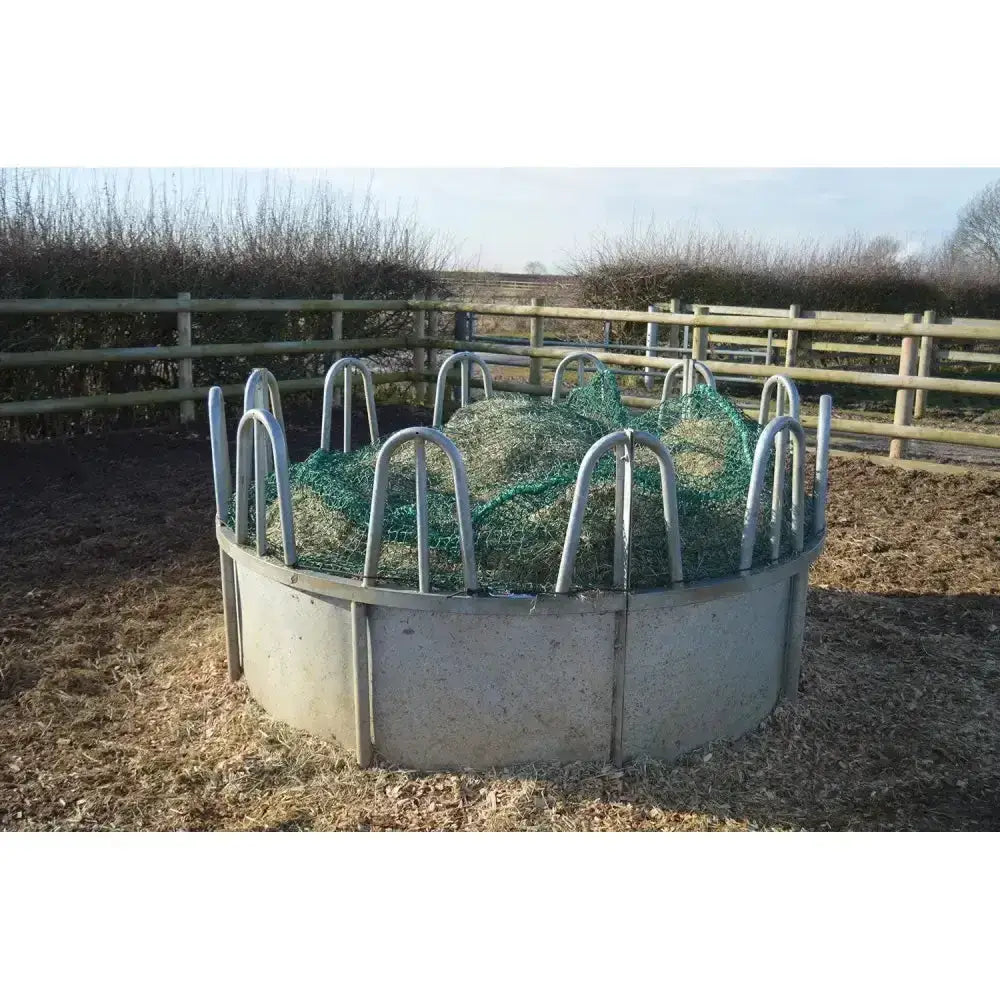 Metallic gray circular feeding ring topper with super strong green trickle net and curved metal bars for easy hay feeding