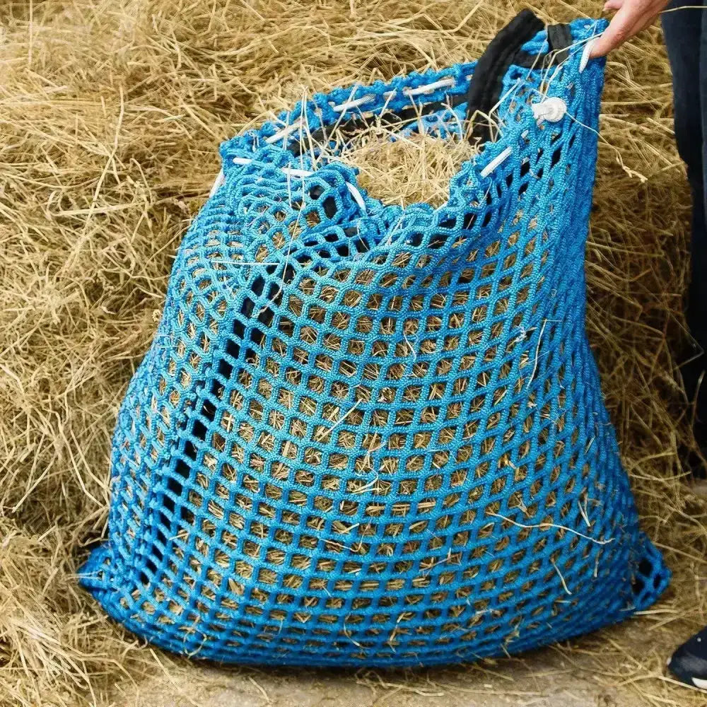 Blue woven mesh hay bag with black handles and white ties from trickle net softee range nets for dry hay feeding