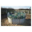 Circular metal trickle net topper feeder with gray concrete base and green mesh inside ring feeders unique design