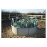 Circular metal trickle net topper feeder with gray concrete base and green mesh inside ring feeders unique design