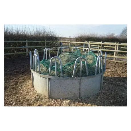 Circular metal trickle net topper feeder with gray concrete base and green mesh inside ring feeders unique design