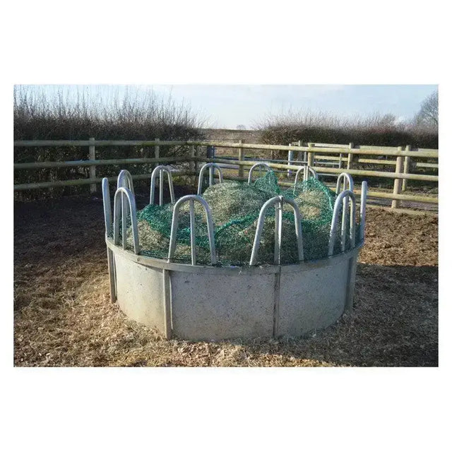 Circular metal trickle net topper feeder with gray concrete base and green mesh inside ring feeders unique design
