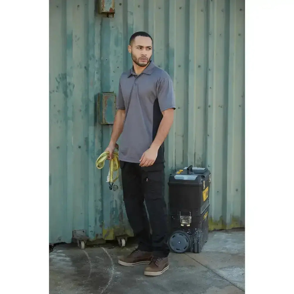 Gray short-sleeved polo shirt with black side panels paired with tuffstuff proflex work trouser black long for workwear