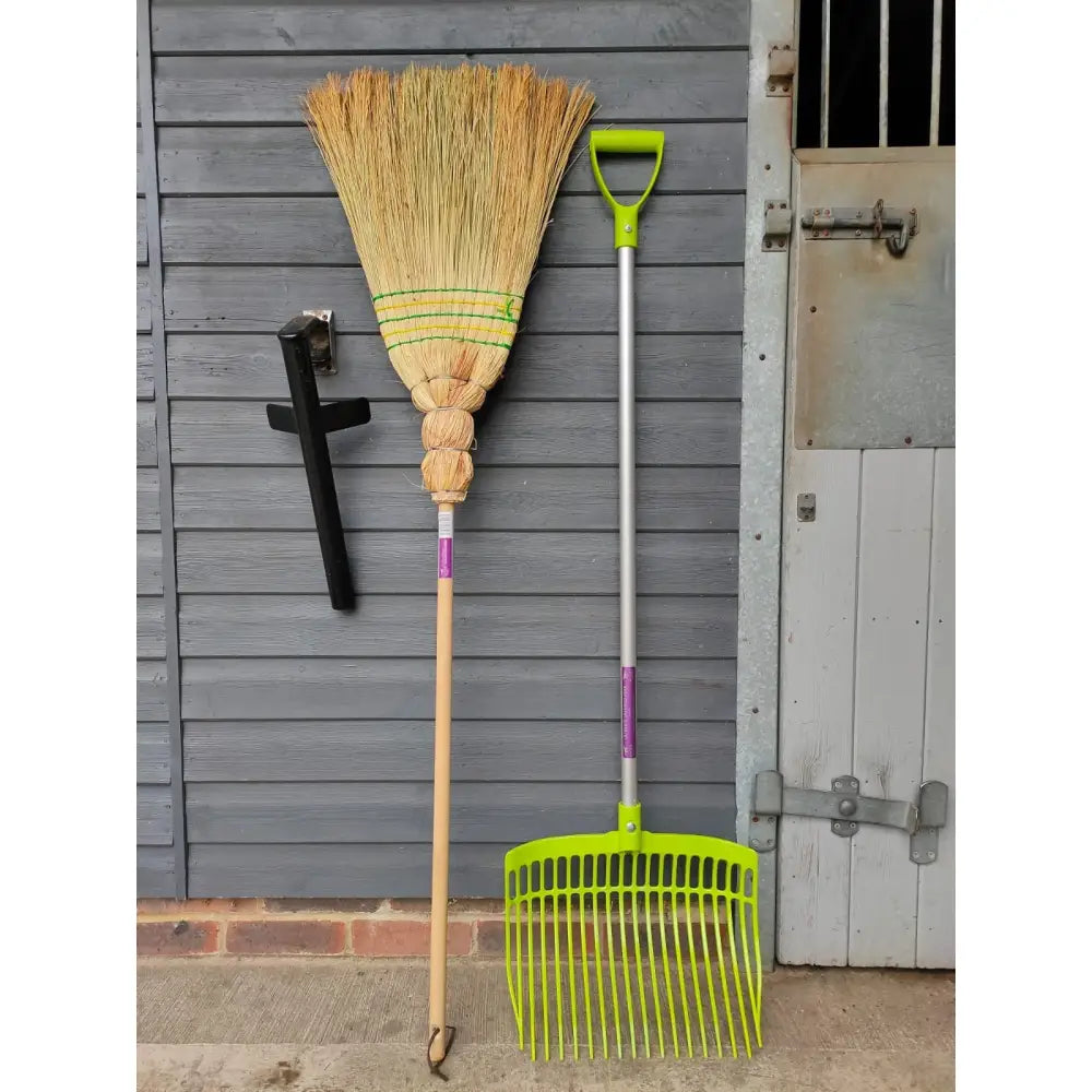 Ultimate corn broom plastic rake with bright lime green head silver metal handle and purple grip accents great for outdoor use