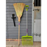 Ultimate corn broom plastic rake with bright lime green head silver metal handle and purple grip accents great for outdoor use