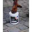 White cylindrical container of ultimate k9 turmeric 450g with black label and colorful icons for working dogs joint support