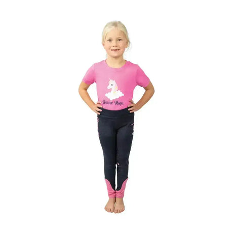 Child wearing a pink short-sleeved unicorn magic t-shirt with a fun bright unicorn design by Little Rider