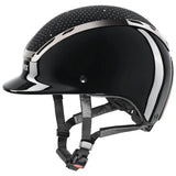 Black glossy uvex exxeed glow riding hat with silver accents dotted top and adjustable straps featuring uvex 3d ias