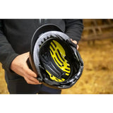 Black uvex exxential iii mips riding helmet with bright yellow interior lining and black padded straps for safety