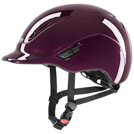 A glossy deep purple uvex kiddox shiny riding helmet with white accent stripes and black adjustable straps for kids