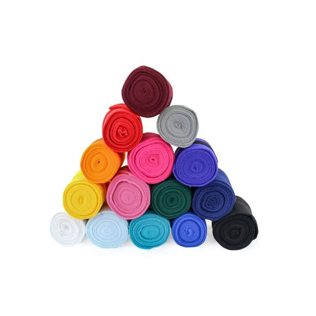 A pyramid of colorful felt rolls in red pink blue yellow and black for vacs deluxe exercise bandages used in dressage